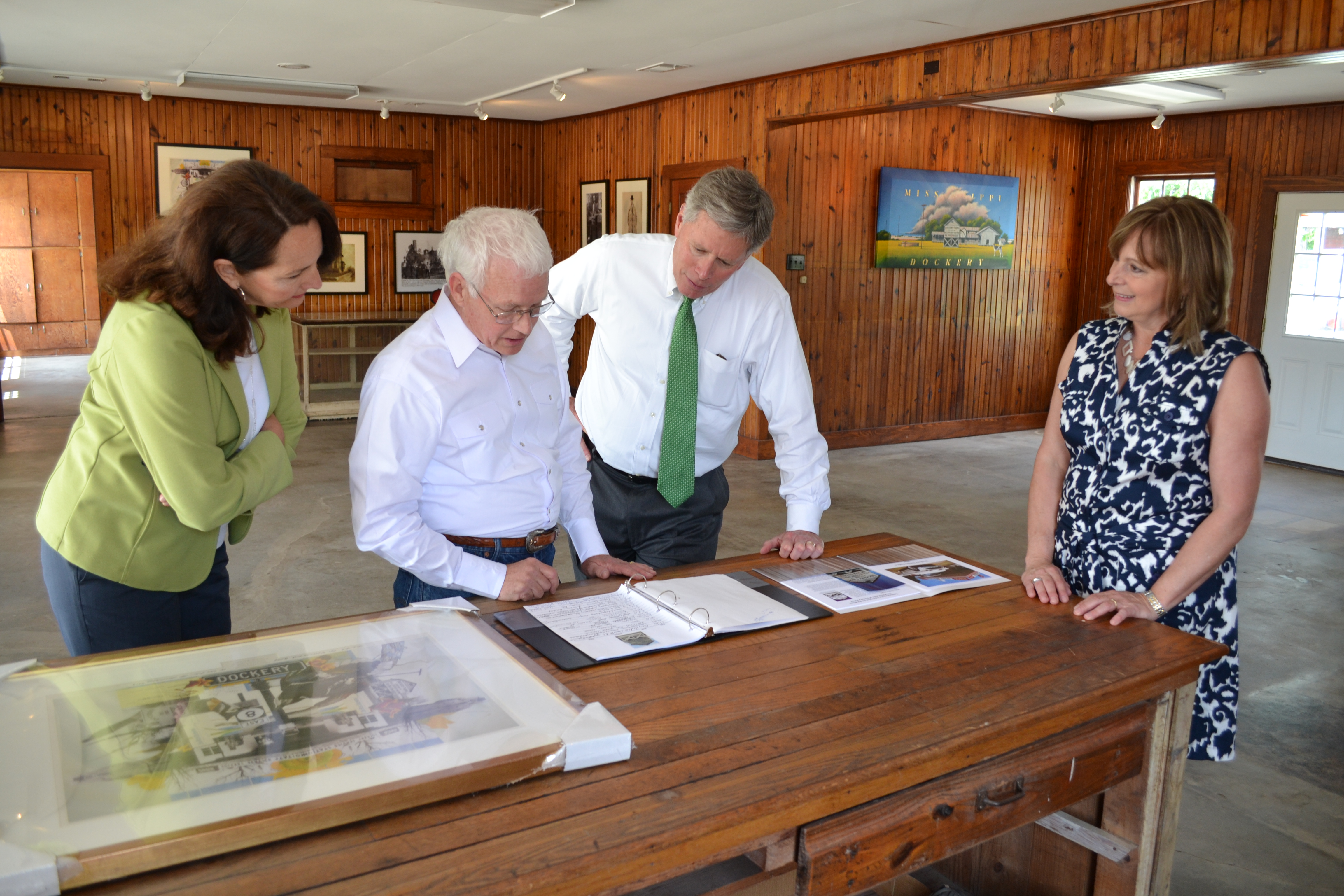 From left, First Lady Nancy LaForge, Delta State Professor Emeritus of Art and Coordinator for the Dockery Farms Foundation Bill Lester, President William N. LaForge and Tennie Lester examine the sign-in book with names of visitors from all over the world who have visited Dockery Farms.